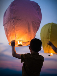 / A boy releasing a floating balloon signifying the start of his journey in overcoming his learning disabilities.